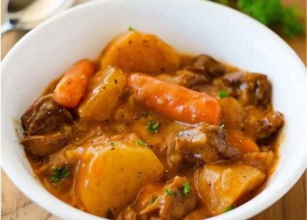 Delicious homemade beef stew simmering in a pot with vegetables.