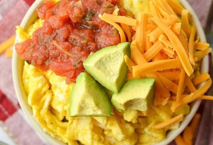 Delicious breakfast burrito bowl with fresh ingredients in a colorful dish