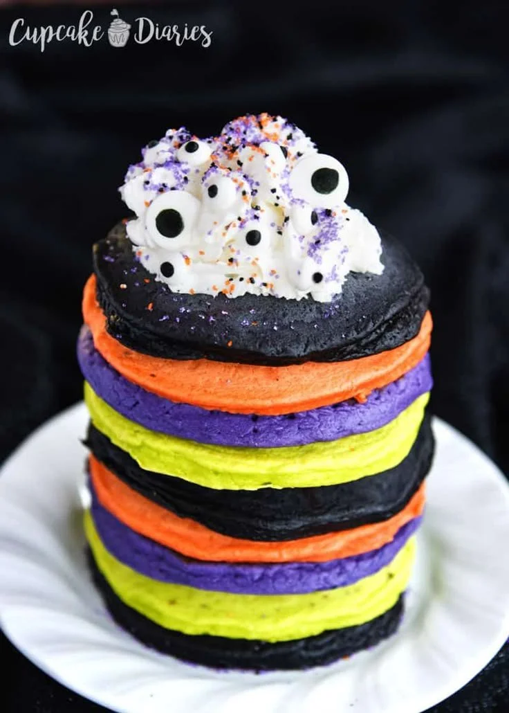 Colorful Halloween pancakes topped with spooky decorations for a festive breakfast