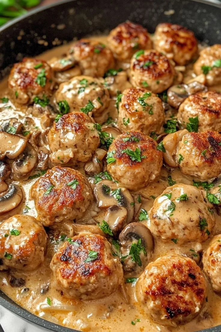 Plate of creamy mushroom chicken meatballs served with herbs