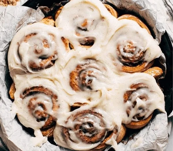 Delicious gluten-free cinnamon rolls topped with creamy frosting