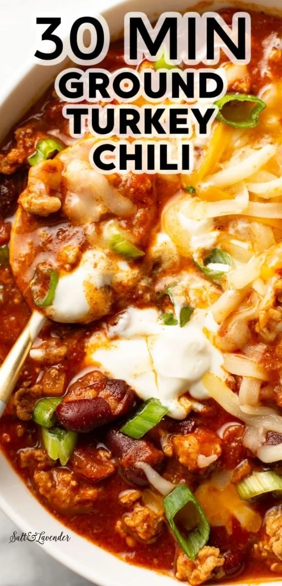 Bowl of hearty ground turkey chili topped with fresh herbs and spices
