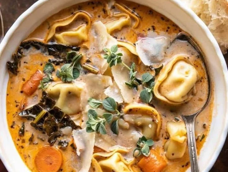 Bowl of creamy tortellini vegetable soup in a slow cooker