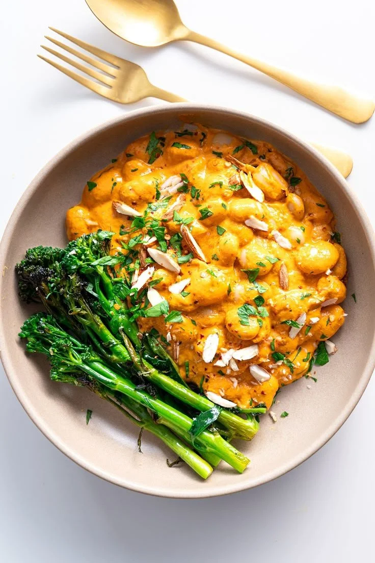 High-protein Romesco butter beans dish garnished with herbs