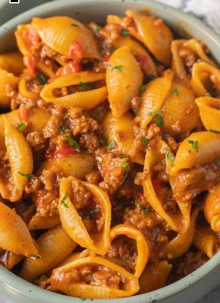 High protein taco pasta dish served in a bowl with toppings.