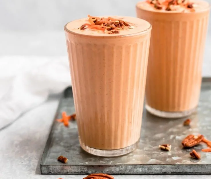 Healthy orange carrot smoothie with ginger in a glass