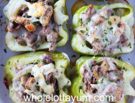 Philly cheese steak stuffed peppers topped with melted cheese and peppers