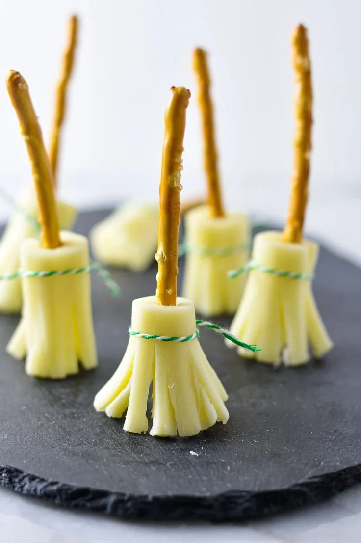 Pretzel witch brooms decorated for Halloween, perfect for festive treats.