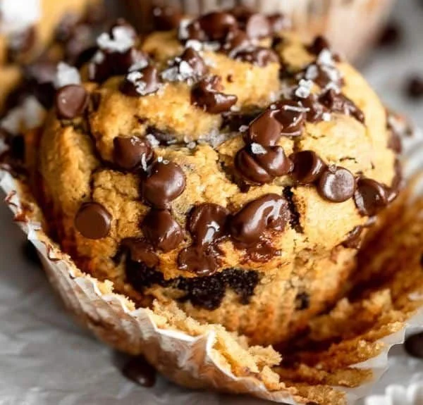 Protein-packed banana chocolate chip muffins on a kitchen counter.