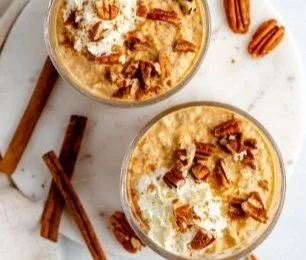 Delicious pumpkin pie overnight oats in a jar topped with spices and nuts.