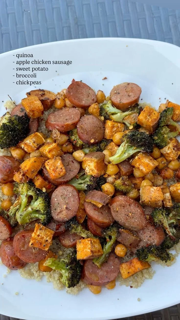 Quinoa chicken sausage bowl with fresh vegetables and herbs