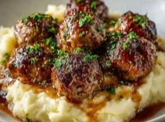 Salisbury steak meatballs with garlic herb mashed potatoes garnished with parsley