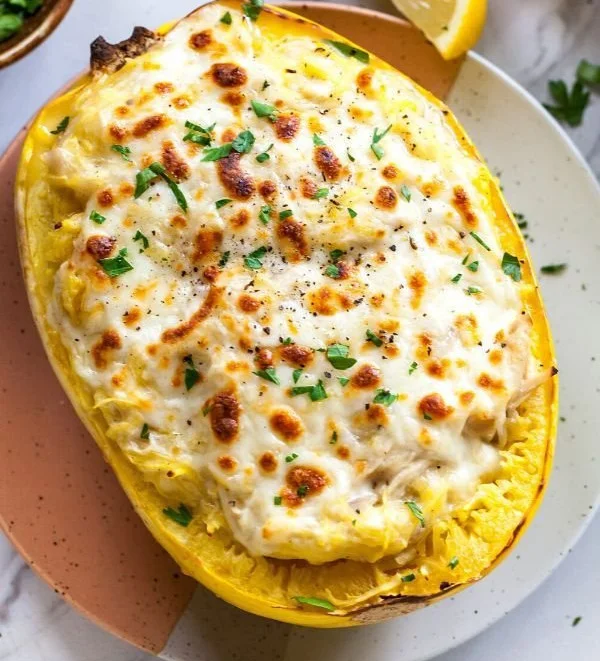 Bowl of Skinny Chicken Alfredo Spaghetti Squash garnished with parsley