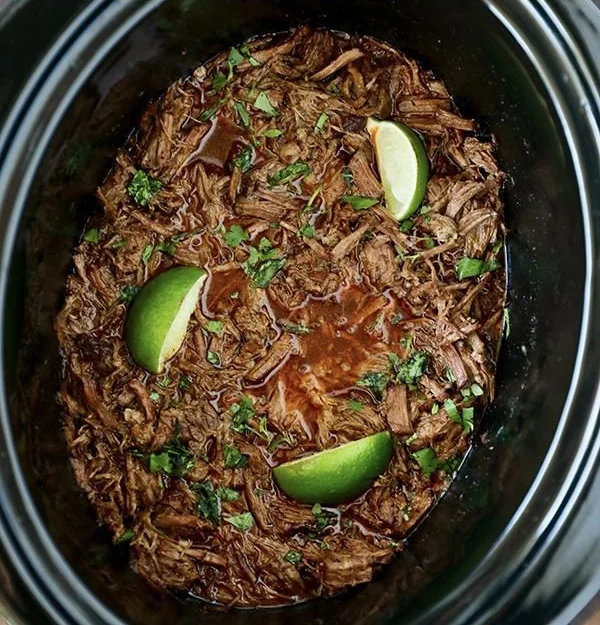 Delicious slow cooker barbacoa served with tortillas and fresh toppings