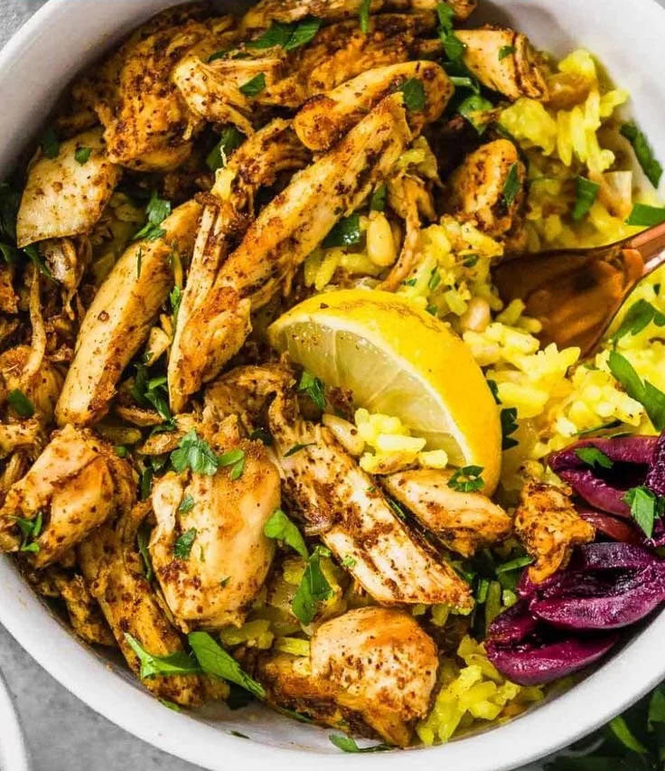Slow cooker chicken shawarma dish garnished with fresh herbs and spices