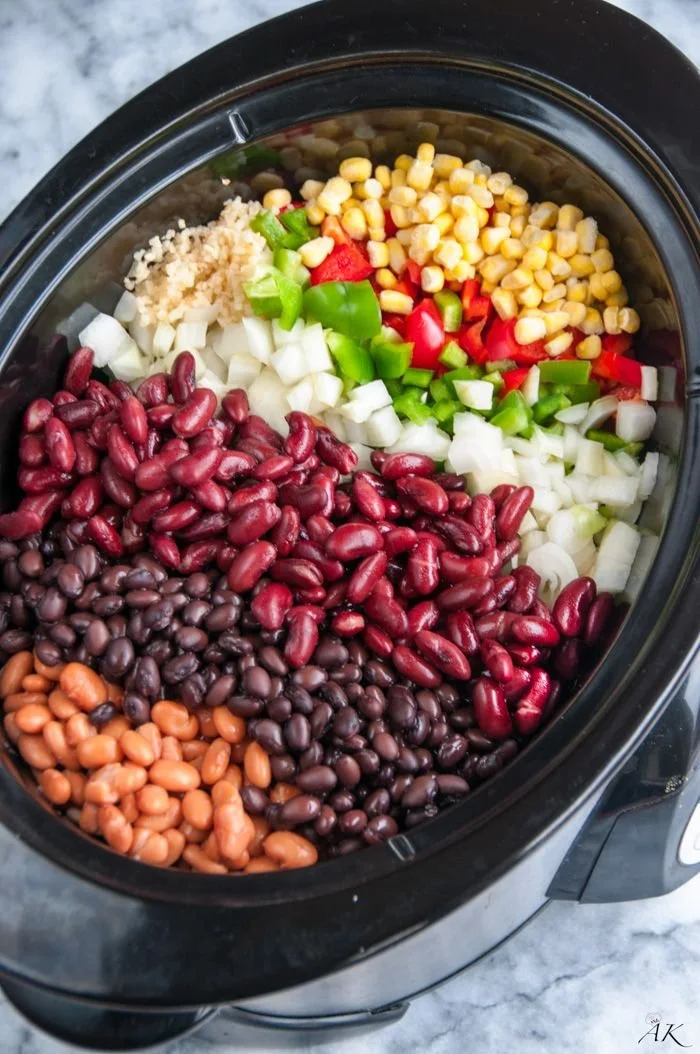 Delicious Slow Cooker Three Bean Chili served in a bowl with toppings.