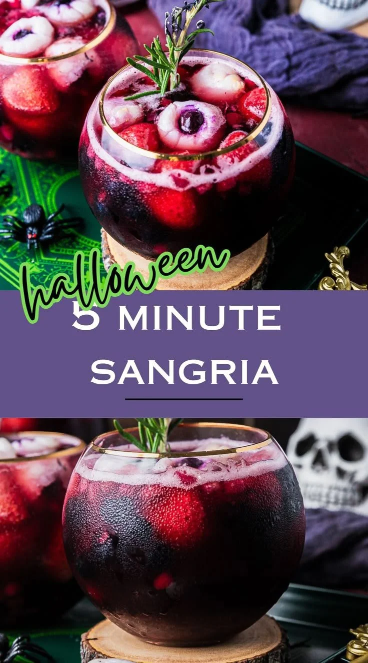 A glass of spooky Halloween sangria with fruits and decorations.