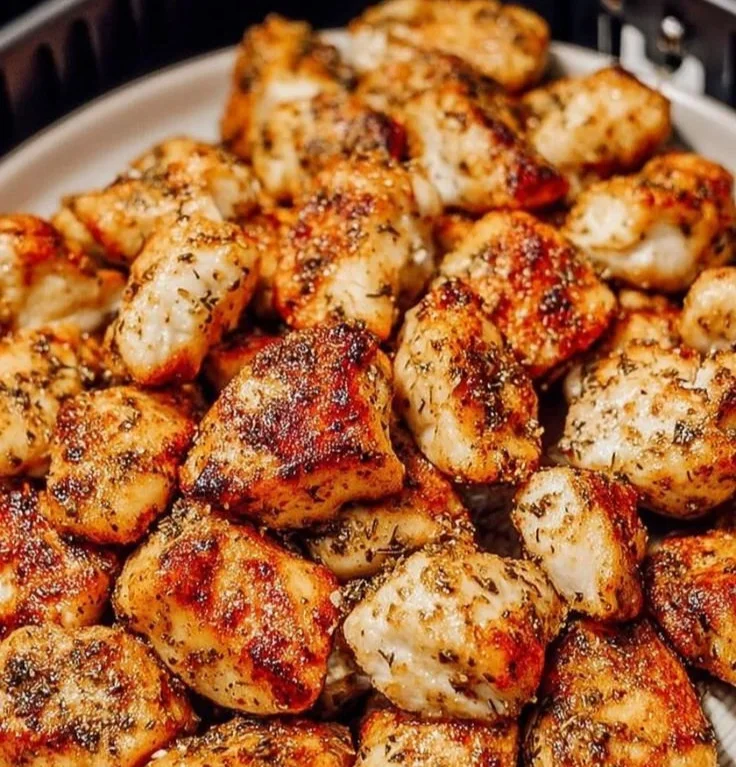 Delicious air fryer boneless chicken bites served with dipping sauce.