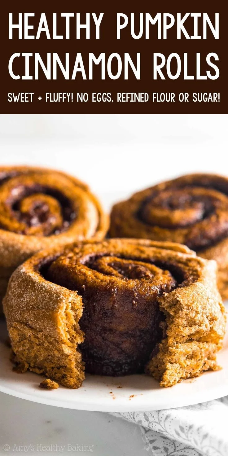 Healthy pumpkin cinnamon rolls with icing on a plate