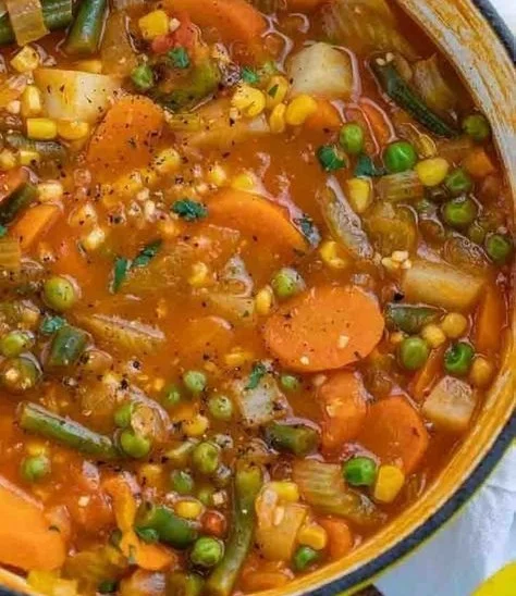 Bowl of colorful vegetable soup with fresh ingredients