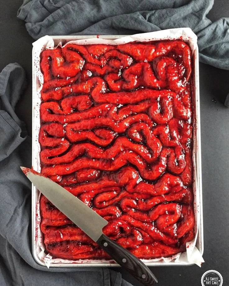 Halloween-themed cinnamon rolls with warm blood topping