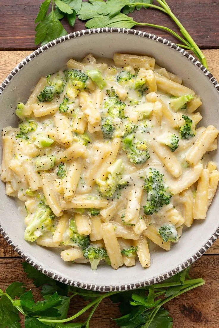 Delicious broccoli cheese pasta served in a bowl with fresh herbs