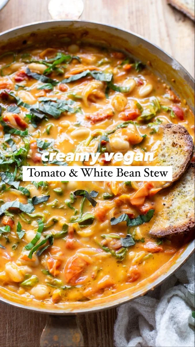 Creamy vegan tomato white bean stew in a rustic bowl