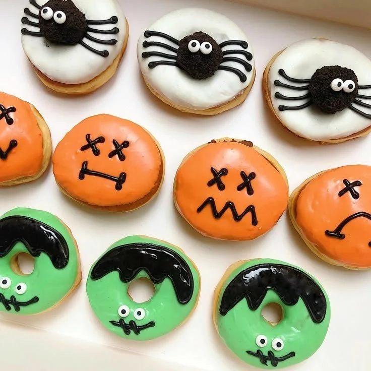 Colorful Halloween donuts, including Frankenstein and mini donut treats.