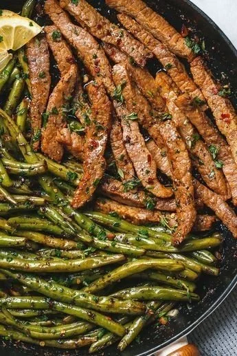 Succulent Garlic Butter Steak served with vibrant green beans on a plate