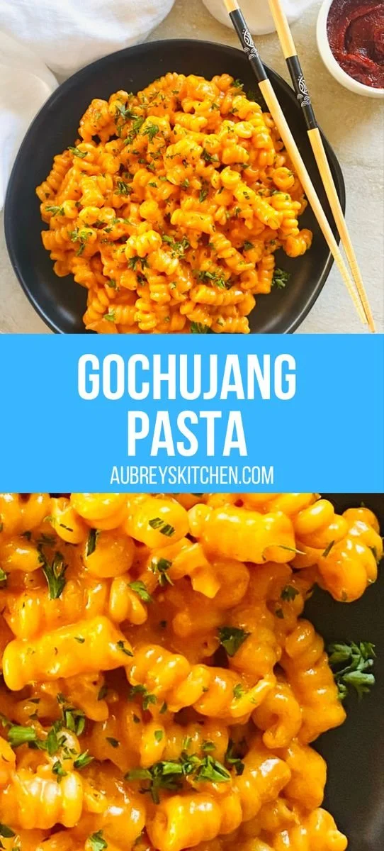 A plate of Gochujang Pasta topped with green onions and sesame seeds.