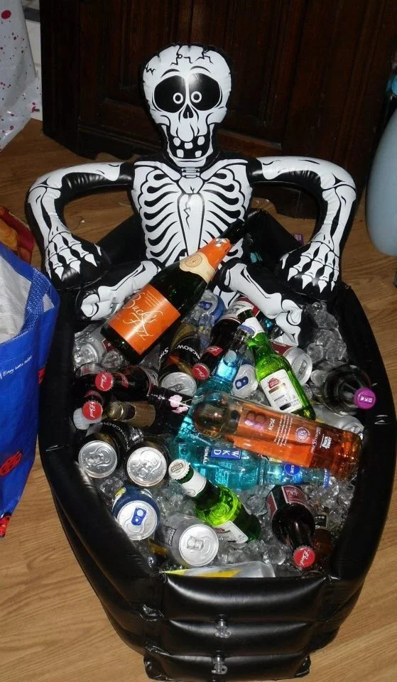 Halloween drinks cooler filled with festive cocktails and party ideas