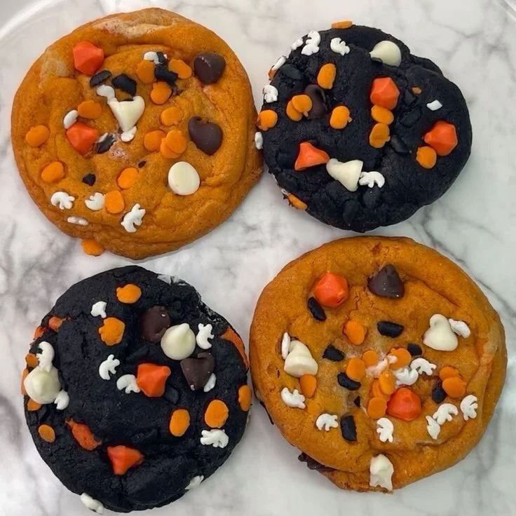 A variety of Halloween treats including spooky desserts and candy on a festive table.