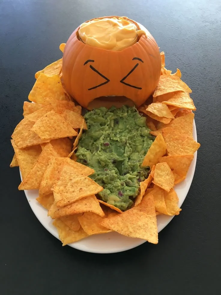 Spooky Halloween Nachos served in a festive pumpkin bowl