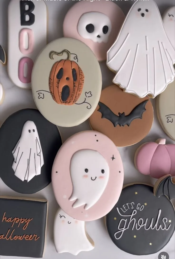 Halloween sugar cookies decorated with ghosts, bats, and pumpkins for festive treat