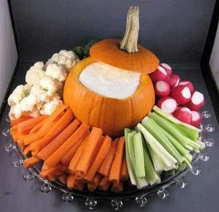 Mini pumpkin Halloween appetizer served with ranch dip and fresh vegetables.