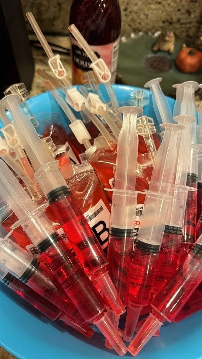 Colorful Halloween party favors including goth gifts and blood shots.