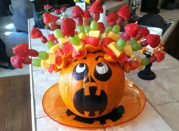 Spooky Halloween fruit salad with colorful fruit kabobs and-themed trays for kids.