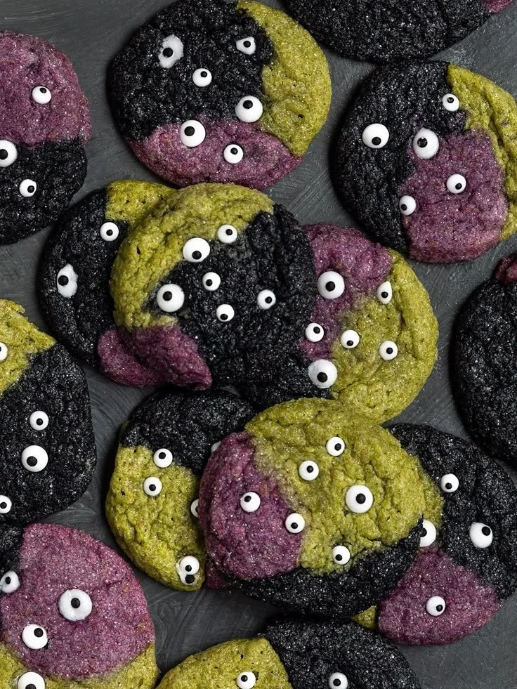 Spooky vegan monster cookies decorated with Halloween themes and vibrant colors