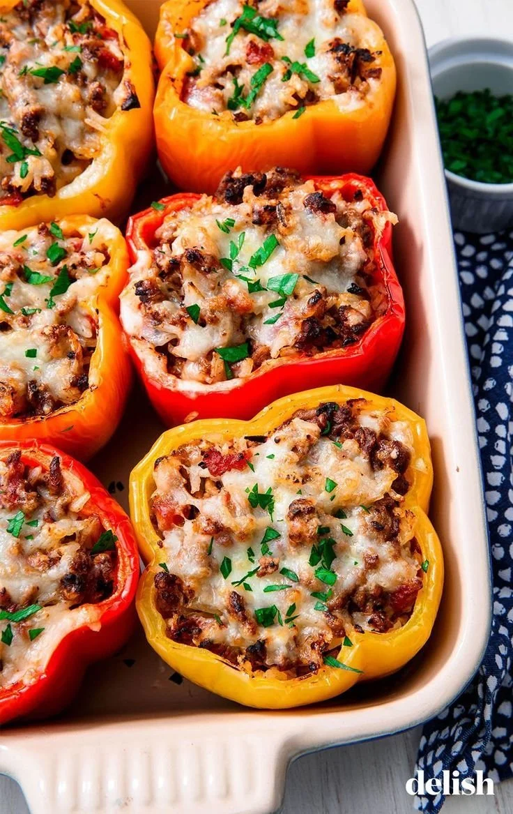 Colorful stuffed peppers filled with rice, vegetables, and spices.